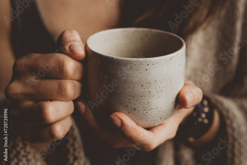 woman with book and cup of coffee