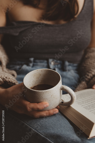 woman with book and cup of coffee