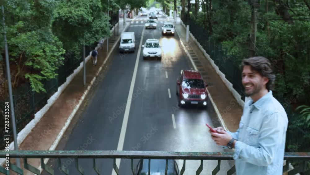 custom made wallpaper toronto digitalView of a young man with smartphone at daytime with traffic and cars landscape in the background. Taking a selfie - video call with smartphone. High quality photo.