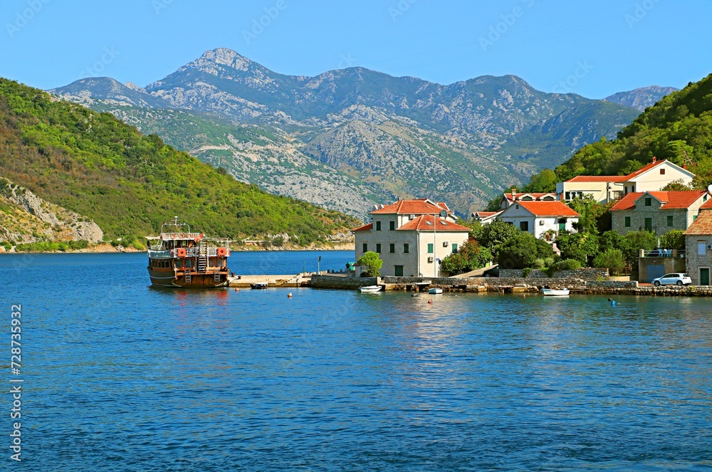 Resort village on the shores of the Bay of Kotor at the foot of the mountains
