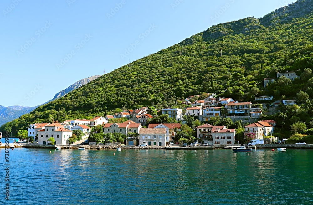 Resort village on the shores of the Bay of Kotor at the foot of the mountains