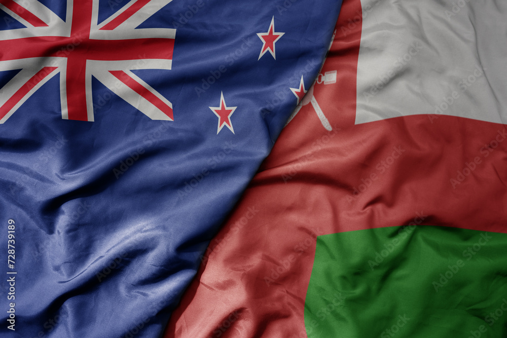 big waving national colorful flag of oman and national flag of new zealand . big waving national colorful flag of oman and national flag of new zealand .