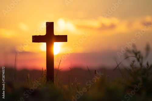 Symbol of faith, cross silhouette against the sky, backlit by the setting sun. Christian god