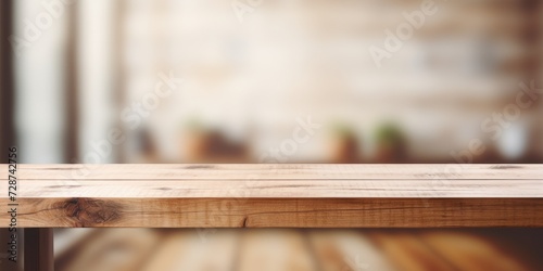 Blurred background of a minimal interior, showcasing a wooden tabletop.