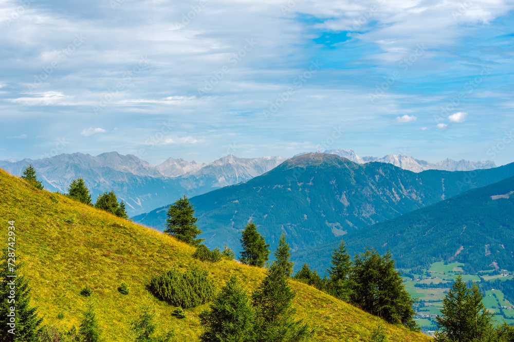 Beautiful panoramic alpine landscape in summer. Mountains near the city of Innsbruck, Austria. In the foreground is the mountain Patscherkofel 2246 m, distinguished by its transmission tower.