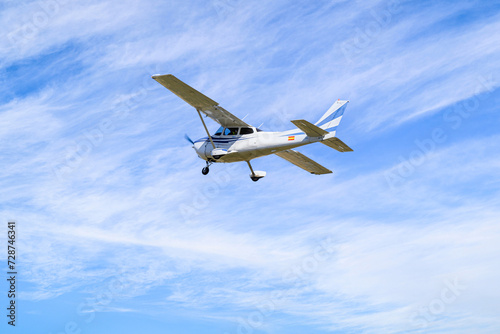 Fototapeta Naklejka Na Ścianę i Meble -  Single engine ultralight plane flying in the blue sky with white clouds	