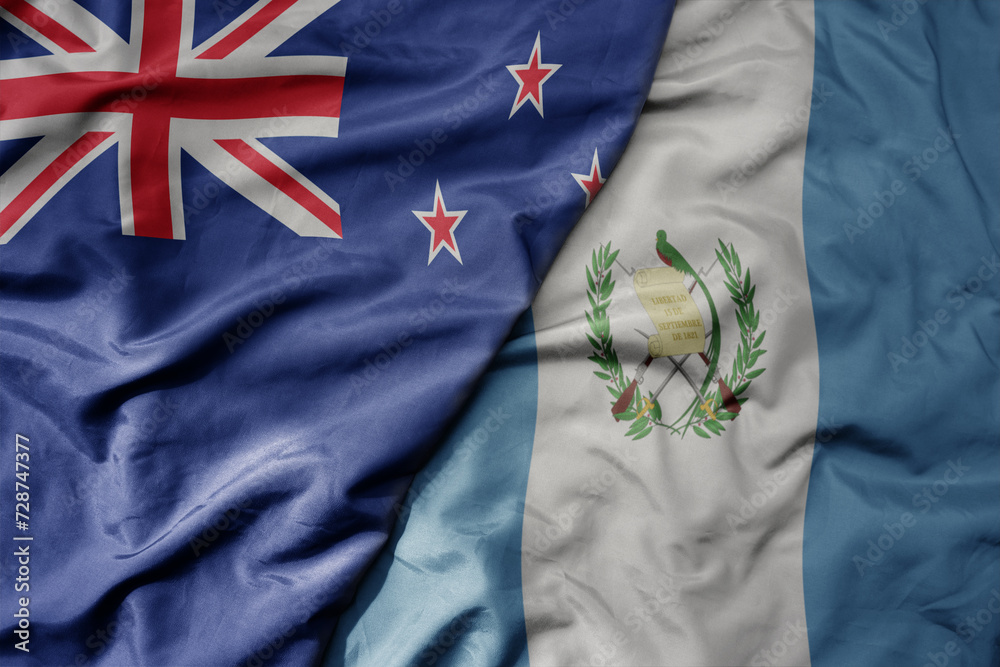big waving national colorful flag of guatemala and national flag of new zealand . big waving national colorful flag of guatemala and national flag of new zealand .