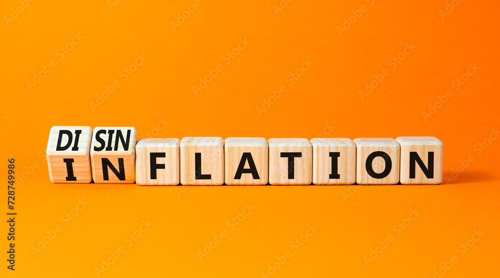 Inflation or disinflation symbol. Concept word Inflation Disinflation on beautiful wooden cubes. Beautiful orange table orange background. Business inflation disinflation concept. Copy space. Inflation or disinflation symbol. Concept word Inflation Disinflation on beautiful wooden cubes. Beautiful orange table orange background. Business inflation disinflation concept. Copy space.