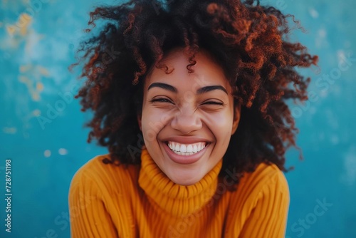 Portrait of a woman expressing joy with a genuine smile © Bijac