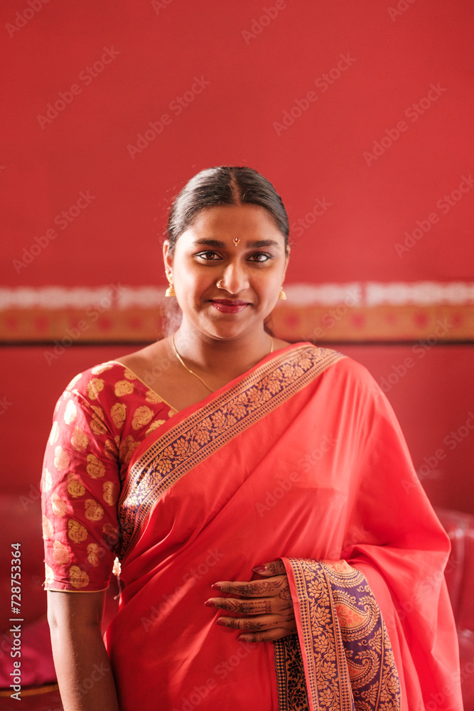 Woman with Hindu features in a portrait with reddish tones. Concept: portrait, religion.