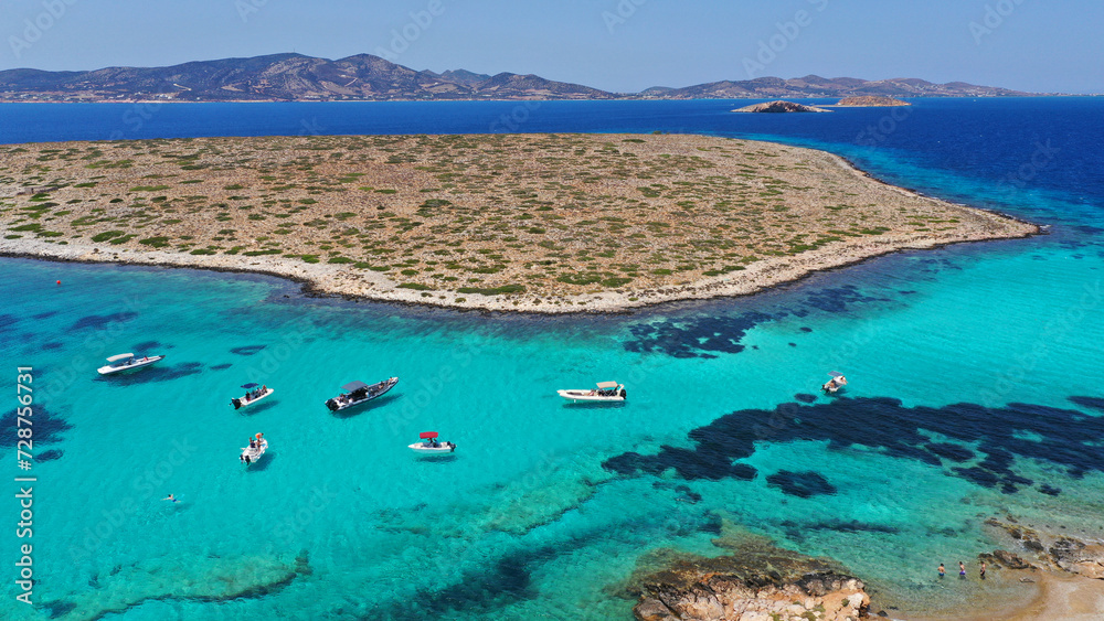 Aerial drone photo of azure paradise blue lagoon of Panteronisi a small islet complex between Paros and Antiparos islands visited by yachts and sail boats, Cyclades, Greece