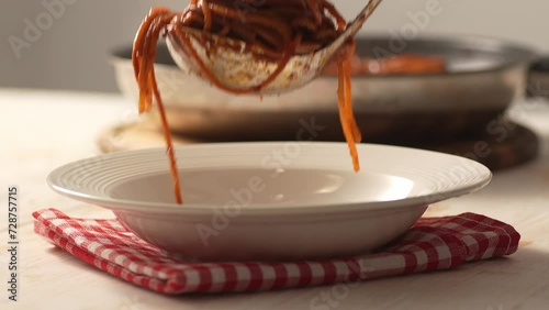 Serving Pasta with Tomato Sauce. Step of Recipe Fried Assassin's Spaghetti Cooking. Close-up, shallow dof. photo