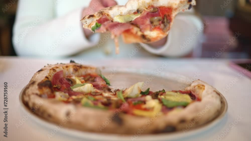 Woman hands slicing an italian pizza at restaurant Woman hands slicing an italian pizza at restaurant