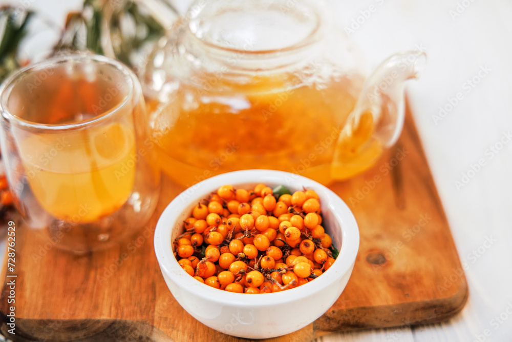 sea buckthorn tea in a clear glass teapot, a natural elixir. sea buckthorn tea in a clear glass teapot, a natural elixir.