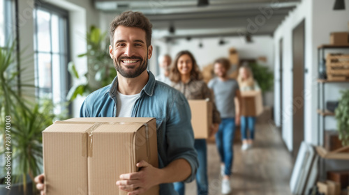 Smiling movers delivering belongings to a delighted family in their new home,...