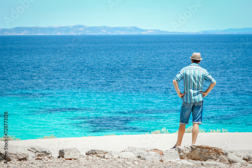 A happy guy near the sea in nature weekend travel