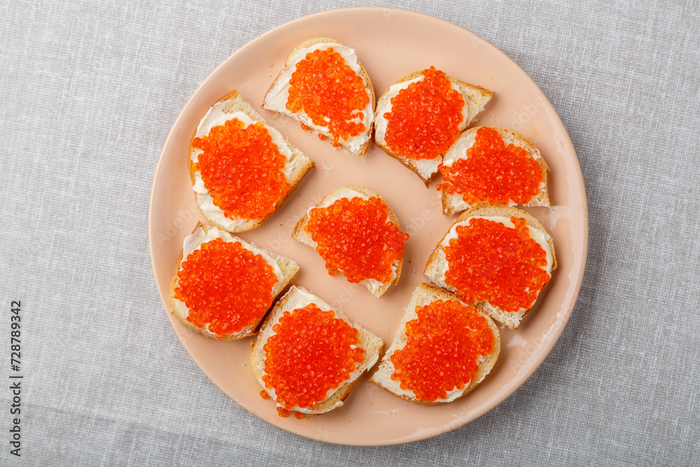 Sandwiches with red caviar on the table on a white tablecloth Sandwiches with red caviar on the table on a white tablecloth