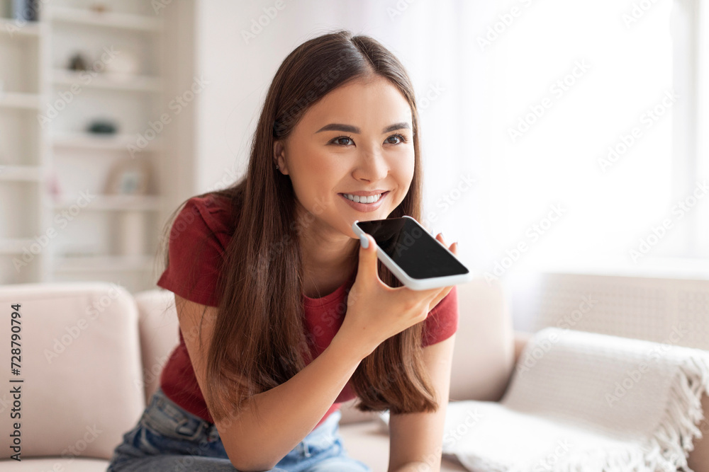 Happy Asian Woman Using Virtual Voice Assistant Option On Smartphone At Home Happy Asian Woman Using Virtual Voice Assistant Option On Smartphone At Home