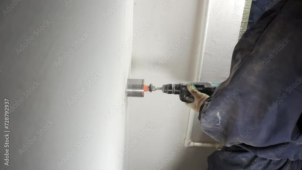 Drilling the wall with a diamond drill. Drilling the wall with a diamond drill.