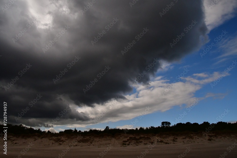 Storm clouds over the forest in Ravent Point, Curracloe, County Wexford, Ireland