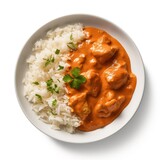 Butter chicken creamy tomato-based sauce with basmati rice on a plate top view isolated on a white background