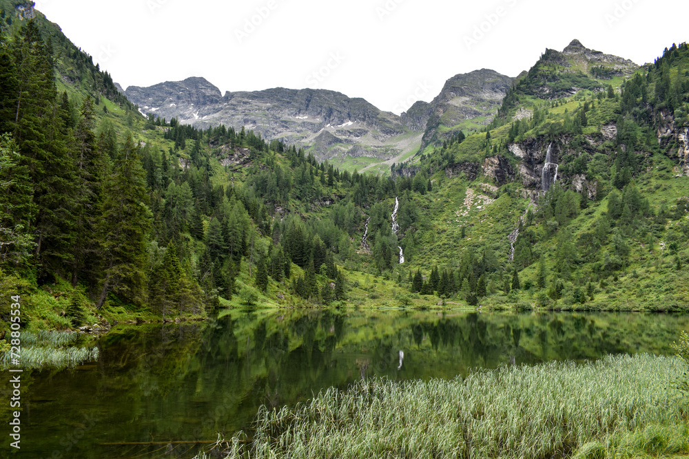 view of lake Huettensee and waterfalls in the Schladminger Tauern, Austrian alps
