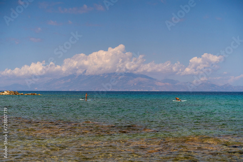 Fototapeta Naklejka Na Ścianę i Meble -  Zakynthos, Greece - August 01, 2020: Tourist doing Paddle board kayaking in mediterranean sea in Zakynthos island of Greece