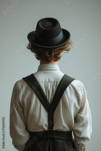 Rear view on stylish man wearing in 19th century times victorian clothes and hat photo