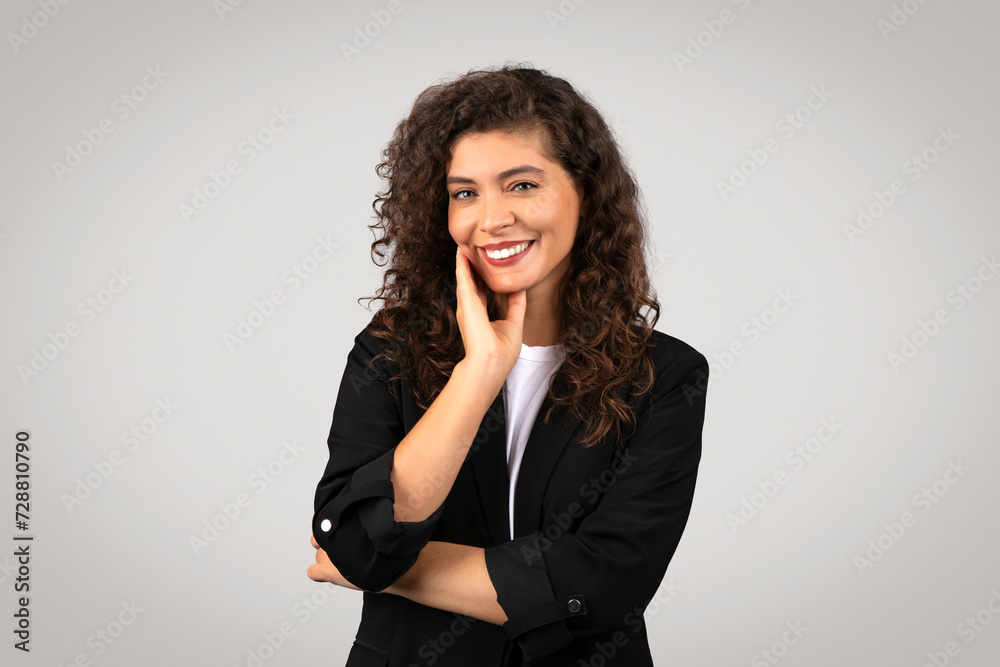 Friendly woman smiling with hand on cheek Friendly woman smiling with hand on cheek
