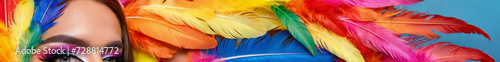 a portrait of a Trans person in a colourful sumptuous rainbow carnival feather suit, circus, drag, drag queen, pride flag, LGBT+, diversity, inclusion, leaderboard, header photo