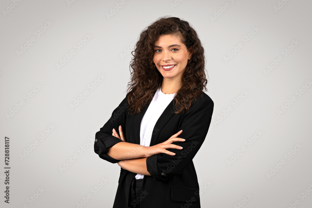 Confident businesswoman with crossed arms smiling Confident businesswoman with crossed arms smiling