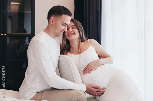 young expectant mother and father at home