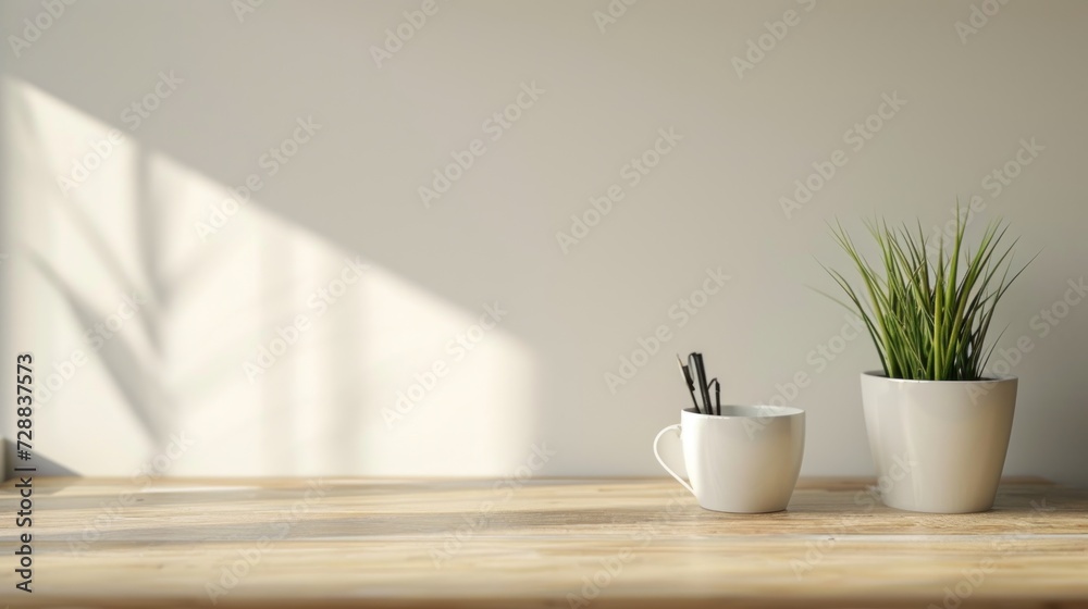 a couple of white cups sitting on top of a wooden table next to a potted plant on top of a wooden table with a white wall in the background. a couple of white cups sitting on top of a wooden table next to a potted plant on top of a wooden table with a white wall in the background.
