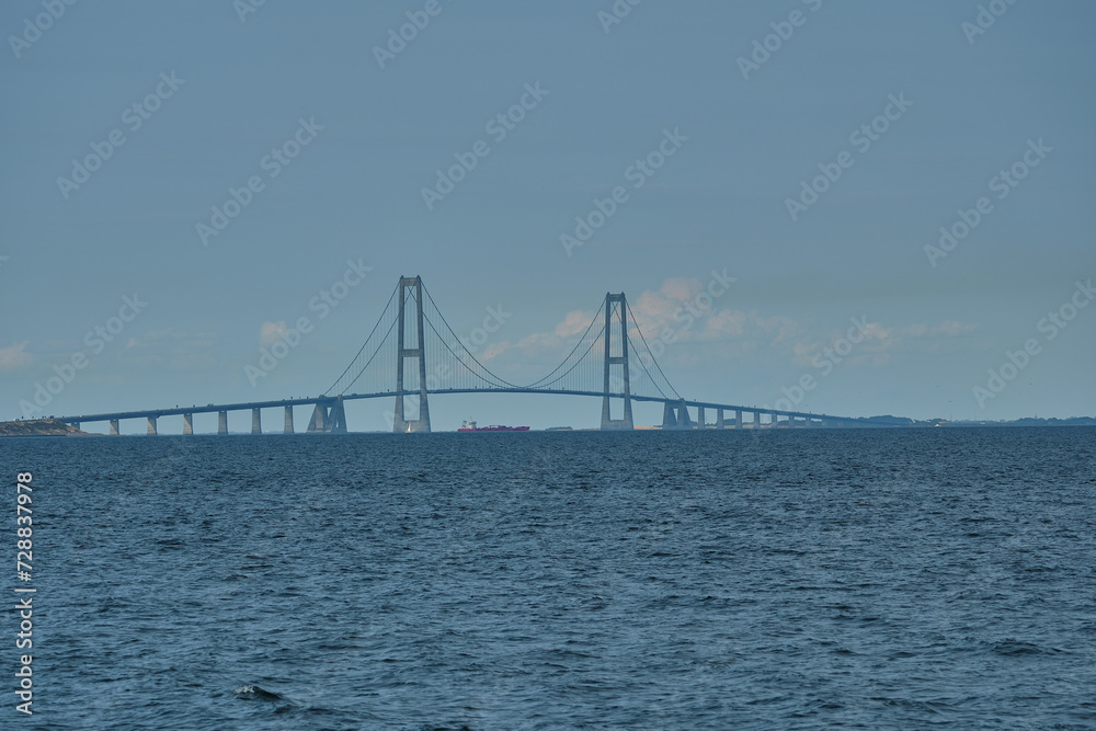 great Storebelt suspension bridge connecting Denmarks islands across the baltic sea on a hazy sunny day. great Storebelt suspension bridge connecting Denmarks islands across the baltic sea on a hazy sunny day.