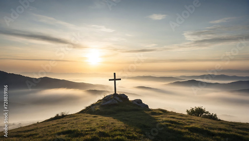 Krzyż na wzgórzu o wschodzie słońca photo