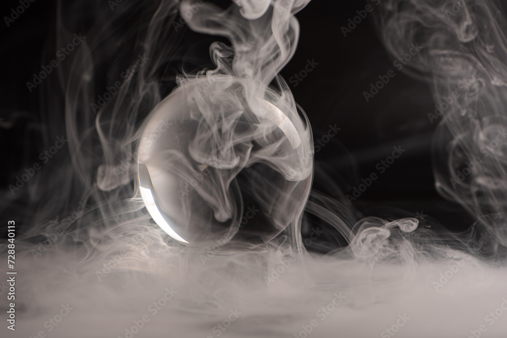 crystal ball, beautiful crystal ball with smoke on black background, selective focus. crystal ball, beautiful crystal ball with smoke on black background, selective focus.