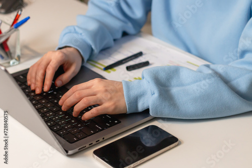 Close up of female hands typing on modern laptop. Businesswoman typing e-mail  buy online using web shop services. Internet and modern wireless technology usage concept.