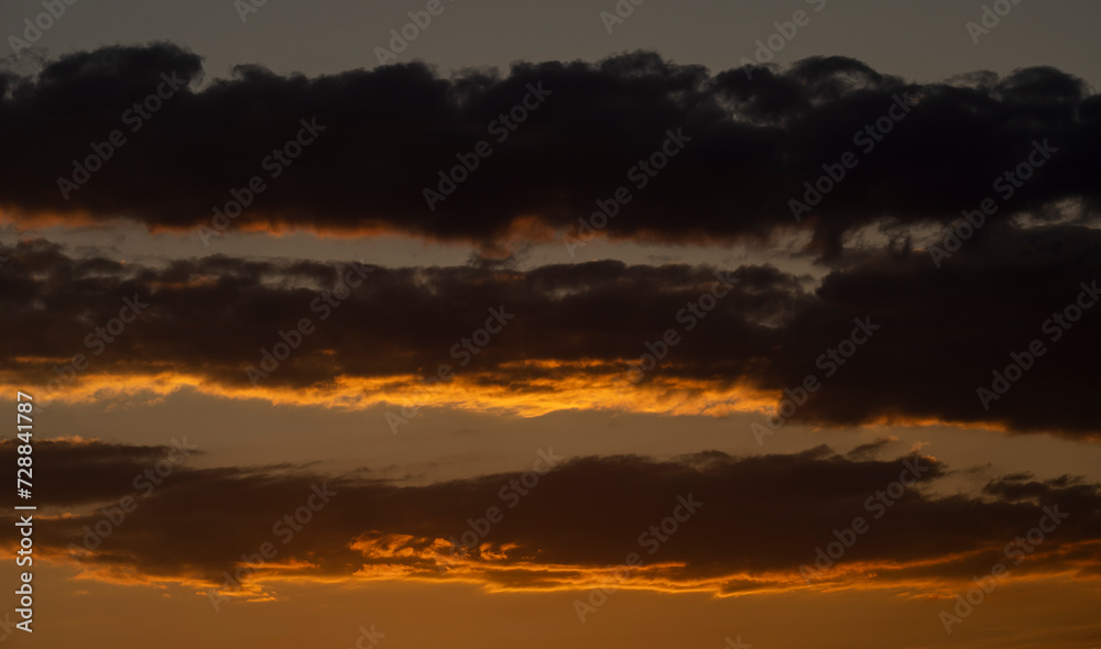 Beautiful sunset in the mountains. Sunset View from the Top of a Mountain. Sunset in strong orange tones in Serbia. The sun falls for horizon, a sunset. Shadows are condensed, beautiful clouds.