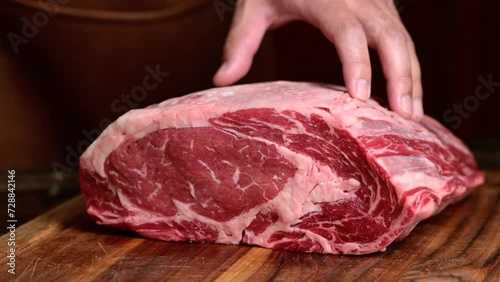 chef cutting beef steak with knife photo