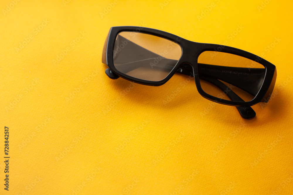 3d glasses on a yellow background, watch a movie