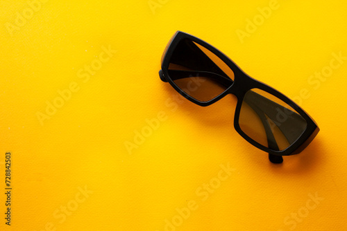 3d glasses on a yellow background, watch a movie