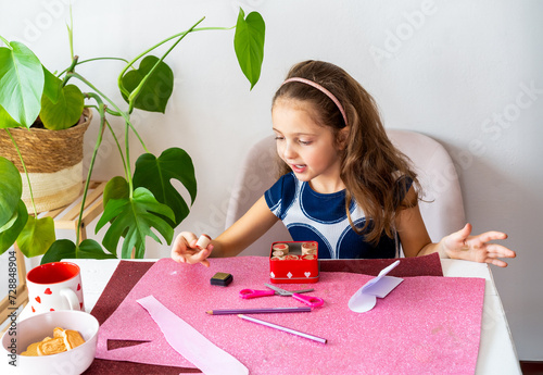 Surprised Child Engaged in Valentine's Day Arts and Crafts