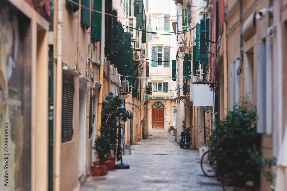 Fototapeta premium Corfu street view, Kerkyra old town beautiful cityscape, Ionian sea Islands, Greece, a summer sunny day, pedestrian streets with shops and cafes, architecture of historic center, travel to Greece