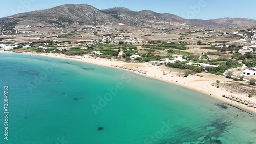 Aerial drone video of famous for surfers sandy beach of Chrysi Akti or Golden beach with crystal clear emerald sea calm with no wind, Paros island, Cyclades, Greece