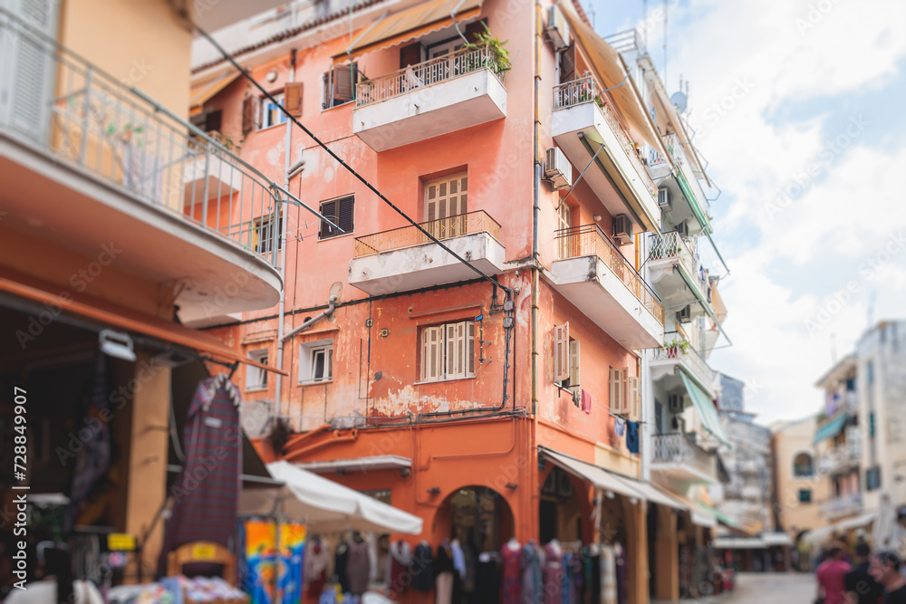 Fototapeta premium Corfu street view, Kerkyra old town beautiful cityscape, Ionian sea Islands, Greece, a summer sunny day, pedestrian streets with shops and cafes, architecture of historic center, travel to Greece