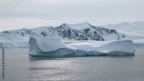 Nature. Icebergs. Arctic winter landscape at global warming problem. Icebergs melt at turquoise ocean bay. Glacier at polar nature environment. Desert white land. Weather and climate change.