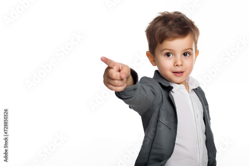 Cute 5 years old boy points somewhere with his finger. Portrait of surprised european child isolated on white background with copy space.