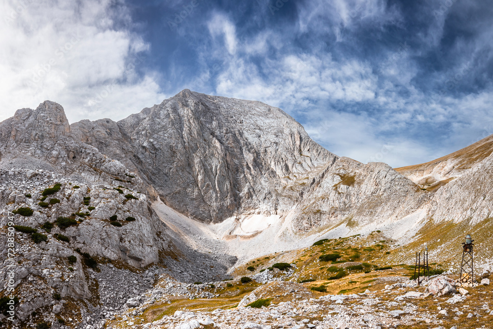 Panoramic view of the Mt. Vihren (the highest peak of Bulgaria's Pirin mountains) southwest wall and the glacier Snezhnika at the foot of it in summer day. Pirin national park near Bansko, Bulgaria. Panoramic view of the Mt. Vihren (the highest peak of Bulgaria's Pirin mountains) southwest wall and the glacier Snezhnika at the foot of it in summer day. Pirin national park near Bansko, Bulgaria.