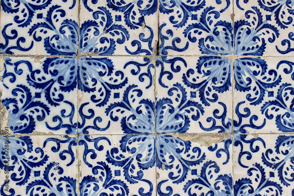 Closeup of decorative floral tiles. Blue traditional Portuguese ceramic tile pattern, azulejos. Beautiful shabby facade, wall decoration of old Lisbon building, Portugal. Decorative background.