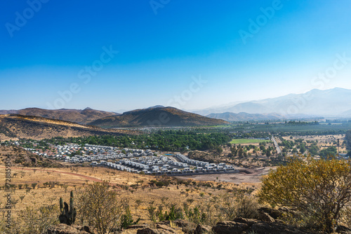 View of the suburbs in the valley. Chicureo, Colina Santiago, Chile.
Houses with a hill in the background. Landscape of the northern part of Santiago
 photo